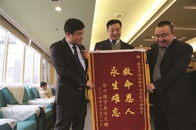 張乃余(中)和兩位救人的同伴一塊領(lǐng)獎。